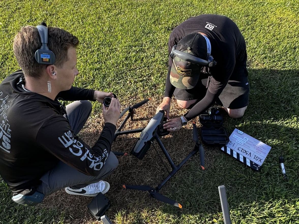 AGL Aerials crew prepping a DJI Inspire 3 before a take, slate in frame